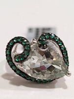Front view of silver ring with pear-shaped green amethyst and green stones on silver swirl design