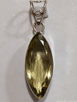 Front view of silver lemon quartz pendant showing faceted marquise stone and silver setting.