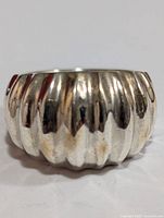 Front view of the chunky silver ribbed band ring showing texture and finish