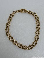 Entire bracelet laid flat on white background showing link pattern and clasp