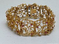 Angled view showing overall filigree design and clasp