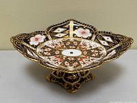 Front angle view of pedestal dish showing overall shape, scalloped rim and base