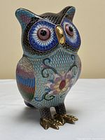 Front view showing face, chest floral motif, and condition