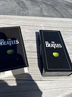 Outer box and slip case covers showing The Beatles branding and green apple logos.