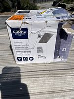 Exterior of Grohe Tallinn shower set box showing product image, brand, and model info. Box has wear and tear.