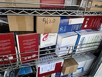 Shelves full of new laser printer cartridges in a variety of box colors including red, white, blue, and brown.