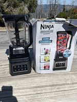 Photo of the Ninja Professional Plus Blender next to its original packaging box showing exterior and pitcher with blades.