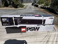 Two new PSW soundbars in original boxes outside on a surface.