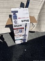 Shark vacuum cleaner box in upright position showing branding and model details.