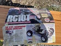 Original box of Team Associated RC10T 1/10 scale RC truck kit showing product details and images, taped and worn due to age.