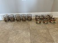 Full view of all 12 highball glasses lined up on floor showing two distinct styles.