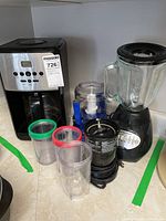 Photo showing full lot: Krupps coffee maker, Hamilton Beach blender, Cuisinart grinder, Magic Bullet blender cups with lids and blades
