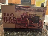 Photo of the front box displaying artwork and model name 1902 Ford 999 with an image of the race car and driver.
