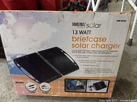 Front of box showing brand, wattage, and briefcase solar charger image