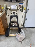 Full front view of Eastwood buffing machine on stand with bag of accessories