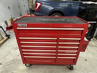 Front view of red US General tool cabinet on wheels showing 13 drawers