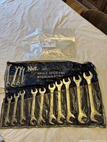 Full set of 14 angle open end wrenches displayed in a black roll-up pouch labeled N&L with sizes 3/8 inch to 1 1/4 inch