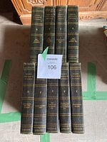 Photo of nine stacked hardcover Mark Twain books with dark covers and gold embossed lettering on spine. Shows titles and condition.
