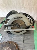 Maximum circular saw showing side profile with blade attached and brand logo visible