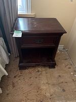 Front view of mahogany nightstand showing single drawer and open shelf