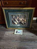 Shows the three prints: a large framed boy and girl print, a smaller framed boy and girl print, and a Robert Bateman bunny print on press board.