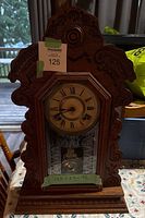 Front view of carved wooden wall clock