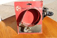 Image shows K+D branded red metal band oil filter wrench on original packaging with visible text and condition