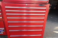 Front view of red MAC Tools chest showing eight closed drawers