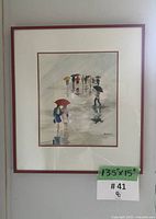 Framed watercolor artwork showing people walking with umbrellas in rain, signed by S. Keane, with size noted on green tape (13.5" x 15")