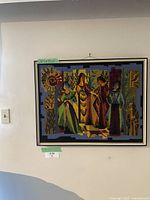 Full frontal view of framed needlepoint hanging on wall with size label visible