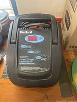 Front view of DieHard battery charger with digital display and control buttons visible