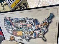 Framed USA map created from various state license plate pieces as artwork.
