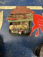 Photo showing Bear Headlight Tester sign with vintage Coca-Cola tray and assorted toy pieces.