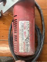 Close-up photo of Milwaukee grinder label showing model and specifications