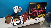 Photo showing the full lot with Strohs Beer light, poker hand lamp, two resin hands, and part of Route 66 sign