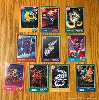 Top side of 10 Zap Pax trading cards depicting colorful cartoon characters such as Rattroll, Eyo, Iron Alien, Aqua Knight, Centipede, Jake, Pimple, Shock Trooper, and Master Higgins.