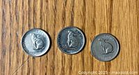 Three 1967 Canadian 5 cent nickels with rabbit design faces visible