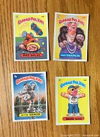 Front view of four Garbage Pail Kids stickers: Pat Splat, Foxy Francis, Spittin' Spencer, and Rod Wad.
