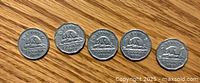 Front (beaver) side of five Canadian 5 cent nickels dated 1940, 1949, 1950, 1955, 1956 showing beaver design on logs and denomination.