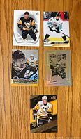Front side of five Sidney Crosby hockey cards showing various designs and player images in Pittsburgh Penguins uniforms