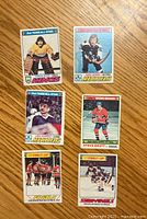 Top side showing the fronts of six hockey cards from the 1977-78 O-Pee-Chee series with players and team all-star designations.