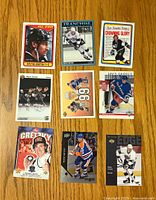 Front of 9 Wayne Gretzky hockey cards arranged in a 3x3 grid on wooden surface