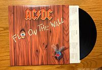 Front of AC/DC vinyl album cover with record partially visible.