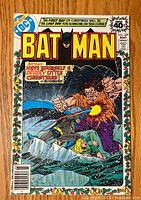 Front cover of Batman #309 comic book showing Batman fighting a large villain and a frozen figure in water, with bright colorful artwork and story teaser text.