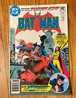 Front cover of Batman #332 comic book showing Batman fighting on rooftop with other characters and title text.