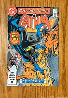 Front cover of Detective Comics #564 featuring Batman fighting Two-Face in action scene.