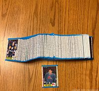 Complete spread of 1989-90 O-Pee-Chee hockey cards arranged side by side showing quantity and condition with Joe Sakic rookie card highlighted separately.