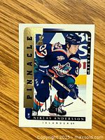 Front side of the signed hockey card showing Niklas Andersson in Islanders uniform with autograph.