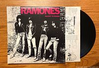 Front of Ramones Rocket to Russia vinyl album cover with record partially visible.