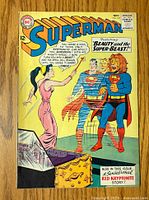 Front cover of Superman comic showing storyline 'Beauty and the Super-Beast!' with the two Superman figures and woman in pink dress.